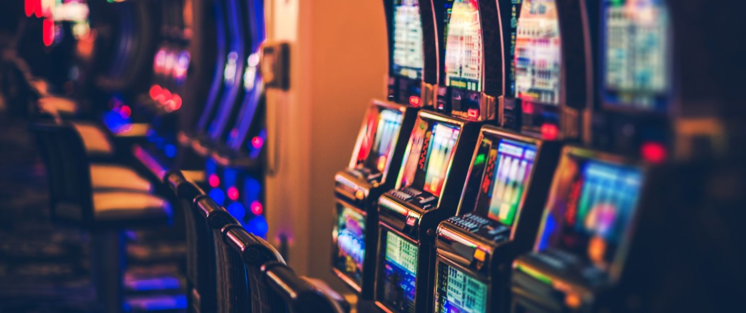 illuminated slot machines in darkroom 948708294 afaf089a8c7b4299aae1e1d70643a14c